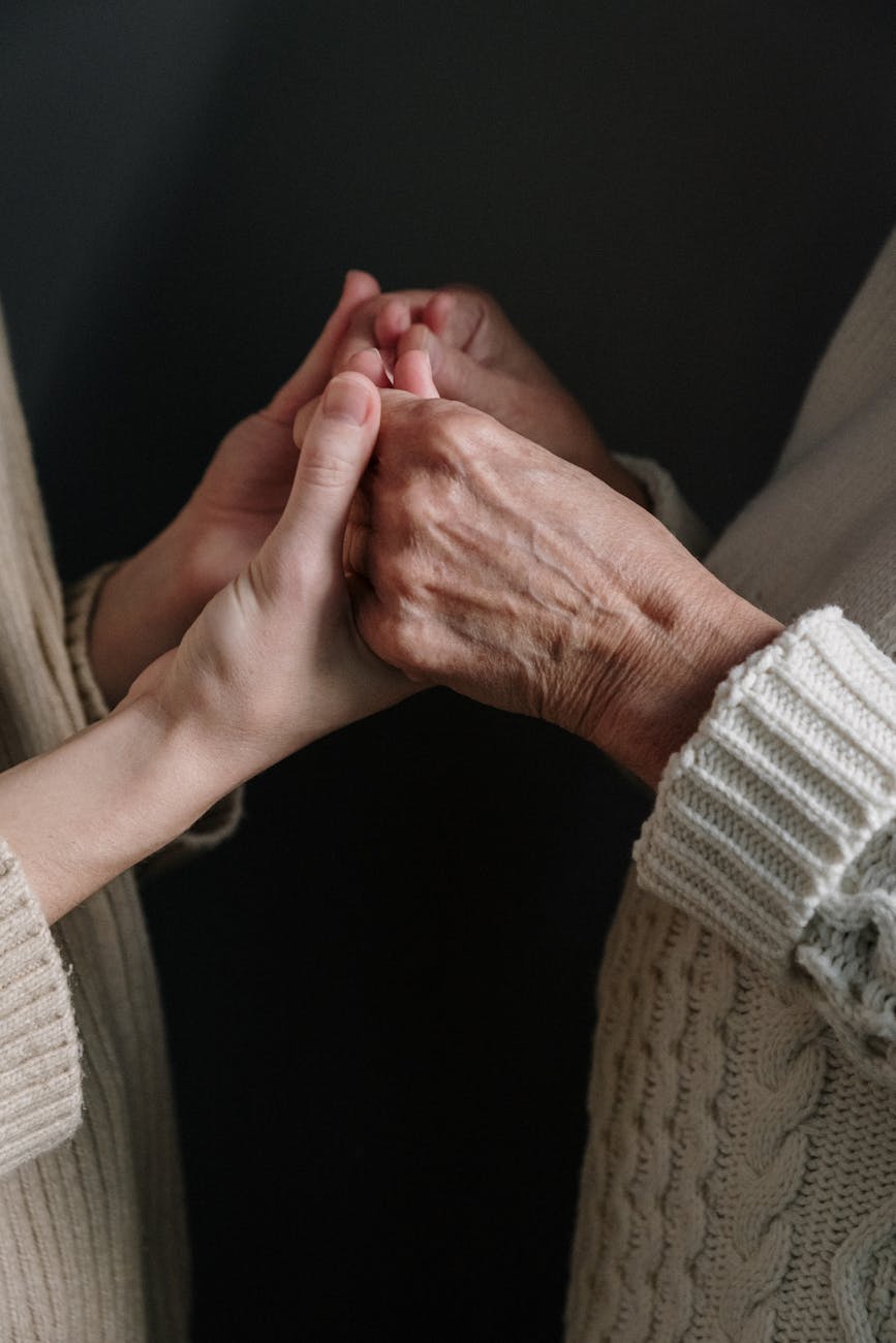 people wearing knitted clothes holding hands
